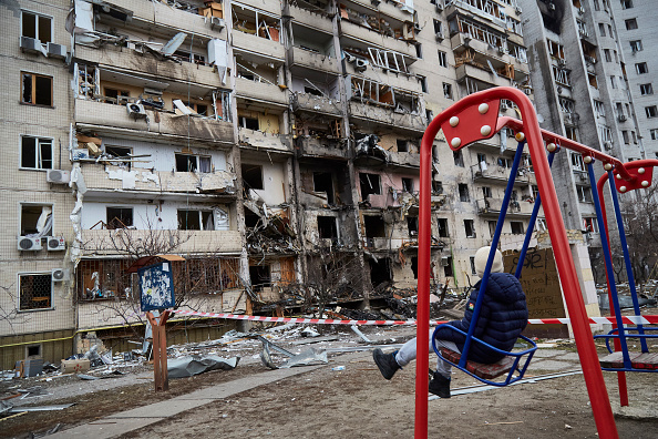 A person on a swing set in Kviv. 