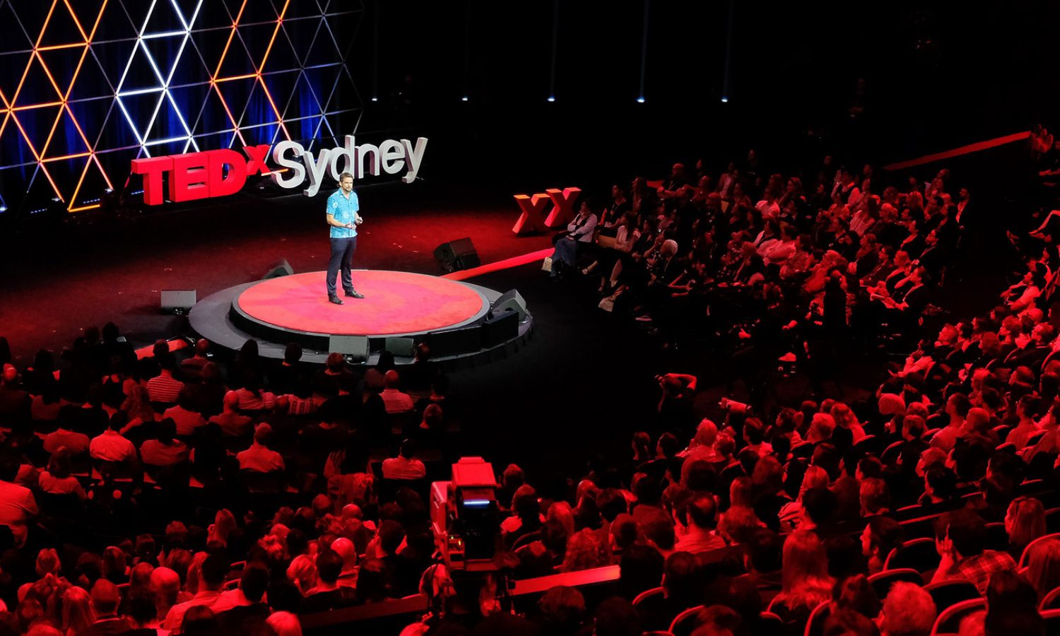 An image showing someone speaking at TEDxSydney