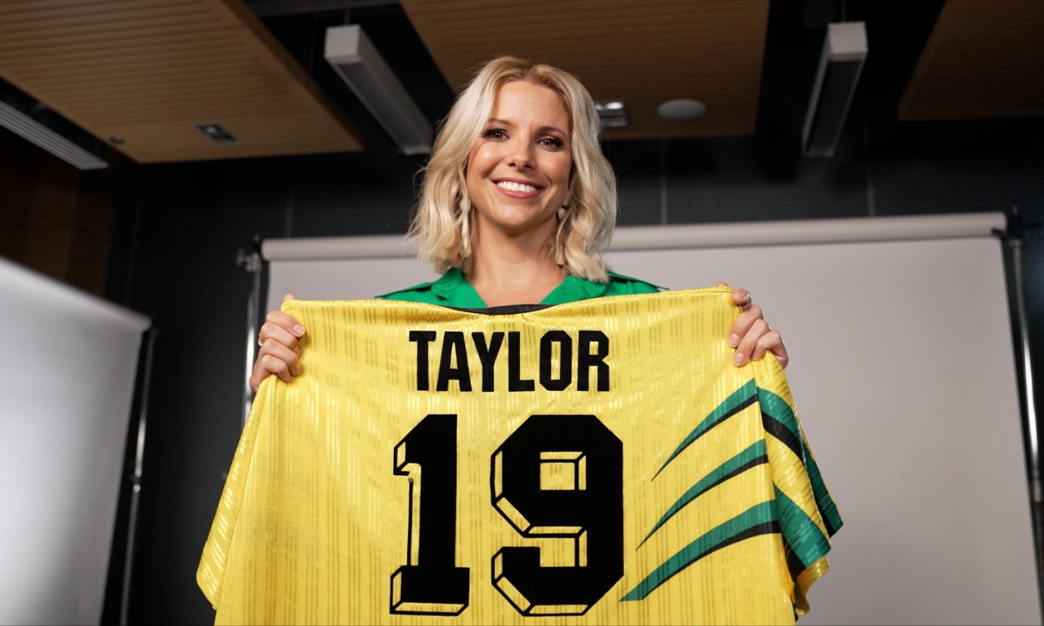 An image of amy duggan holding her matildas shirt