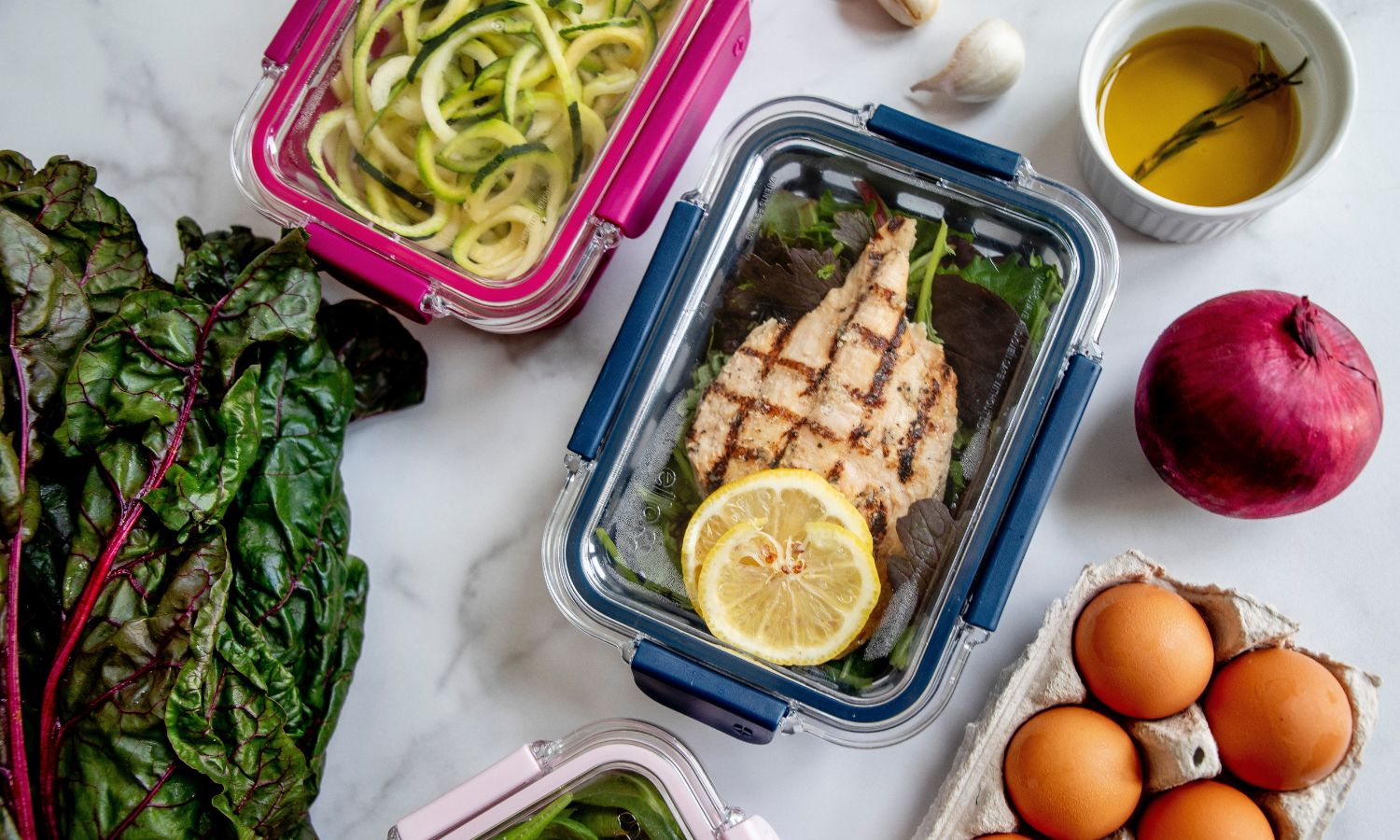 Clear containers with leftover food, ready for the fridge.