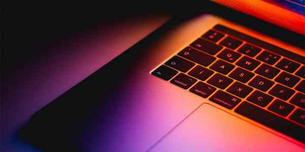 Close up of a Mac Book keyboard and trackpad.