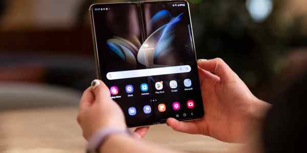 Close-up of a woman's hands holding the Samsung Galaxy Z Fold4.