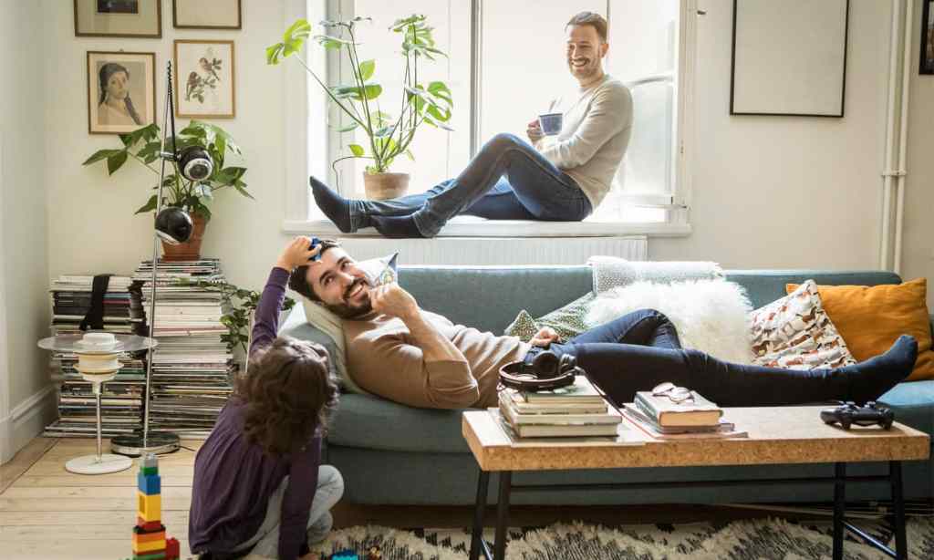 Young girl playing with her dads in the lounge room.