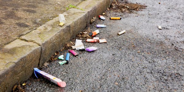 An image showing vape waste on the street to illustrate how to dispose of a vape properly