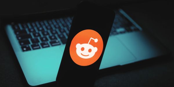 An image showing the Reddit logo against a dark laptop background to illustrate the Reddit blackout.