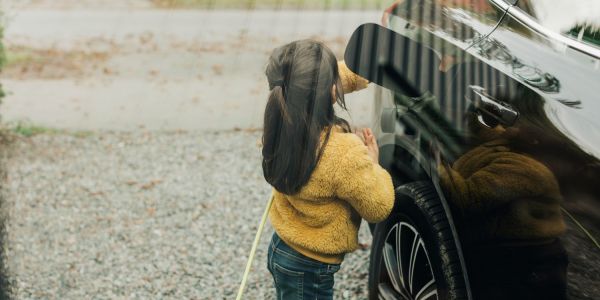 An image showing a girl charging an EV in Australia at home.