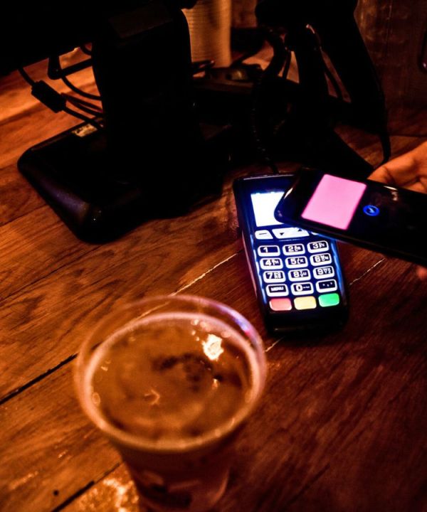 An image showing someone paying for beer.