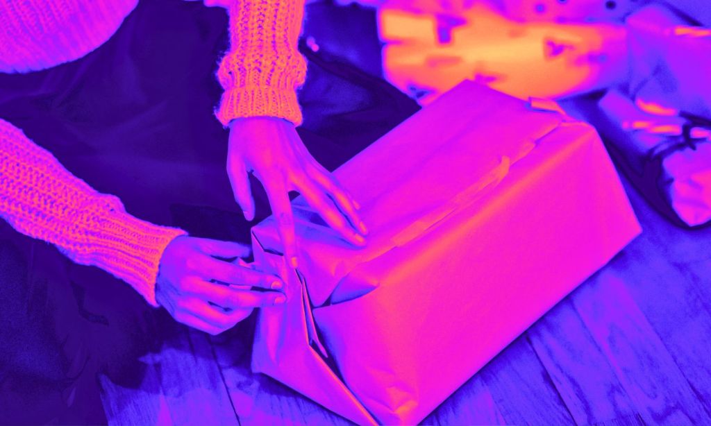 A woman wrapping a christmas present that may go to waste in australia